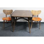A mid 20th century teak G Plan sideboard together with a drop leaf table and two chairs