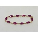 A 14ct yellow gold ruby and diamond bracelet, set with ten marquise-cut rubies (14.