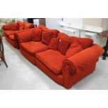 A contemporary four seater and two seater settees upholstered in burnt rust coloured fabric,