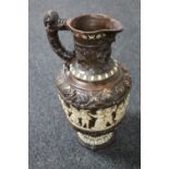 A continental embossed pottery ewer,