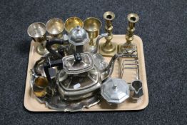 A tray of assorted plated wares, brass candlesticks,