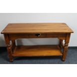 A Mexican pine two tier side table fitted with a drawer