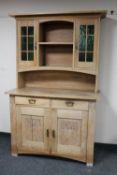 An early 20th century continental oak dresser fitted cupboards and drawers beneath