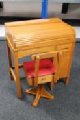 A mid 20th century child's roll top desk and chair