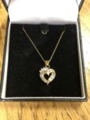 A 10ct gold diamond set heart pendant on chain