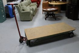 A metal flat bed trolley with handle