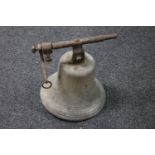 An antique cast metal church bell with bracket