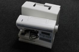 A Viking Husquvarna Interlude 445 electric sewing machine in case with foot pedal