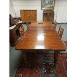 A Victorian oak extending dining table with two leaves,