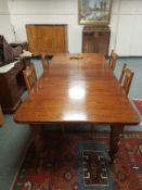 A Victorian oak extending dining table with two leaves,