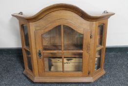 An antique oak wall cabinet