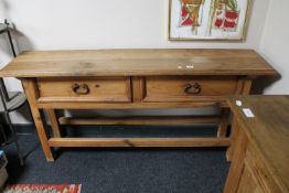 A Mexican pine hall table fitted two drawers