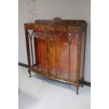 A 1930's walnut double door display cabinet