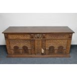An early 20th century heavily carved oak sideboard CONDITION REPORT: 175cm wide by