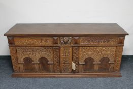 An early 20th century heavily carved oak sideboard CONDITION REPORT: 175cm wide by