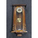 An antique mahogany cased Vienna wall clock, with pendulum,