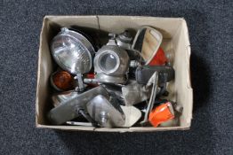 A collection of early car parts including lights, Lucas headlight with bulbs,