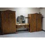 A three piece 1930's walnut bedroom suite comprising of lady's and gent's wardrobes and kidney