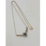 A 10ct gold emerald and diamond set pendant on chain