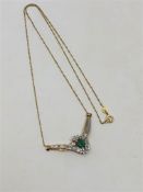 A 10ct gold emerald and diamond set pendant on chain