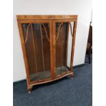 A 1930's walnut double door display cabinet