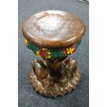 A carved hardwood and painted elephant stool