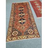 A Khamseh rug 277 cm x 127 cm