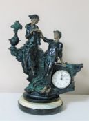 A continental style resin figural mantel timepiece