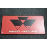 A hand-painted metal sign 'Massey Ferguson'