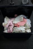 A tin trunk containing bedding,