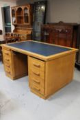 A 20th century oak twin pedestal desk with leather inset panel (slide missing)