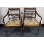 A pair of bergere seated armchairs