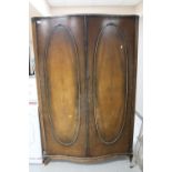 A walnut bow fronted double door wardrobe