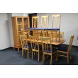 A fourteen piece beech finish dining room suite comprising four door sideboard, extending table,