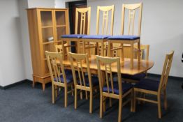 A fourteen piece beech finish dining room suite comprising four door sideboard, extending table,