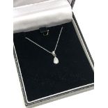 A 10ct white gold single stone diamond pendant on chain