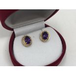 A pair of 10ct gold amethyst and diamond earrings