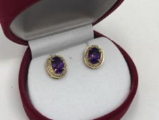 A pair of 10ct gold amethyst and diamond earrings