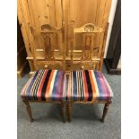 A set of four dining chairs in striped upholstery