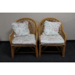 A pair of cane conservatory armchairs