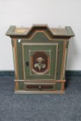 An antique hand painted wall cabinet