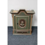 An antique hand painted wall cabinet