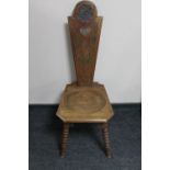 A carved oak spinning chair on bobbin legs