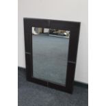 A contemporary leather framed mirror
