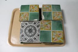 A tray of assorted glazed Victorian fireplace tiles