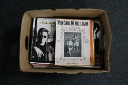 A box of music books and sheet music