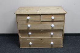 A Victorian pine five drawer chest with white porcelain handles
