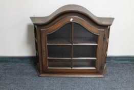 An oak arched topped wall cabinet