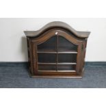 An oak arched topped wall cabinet
