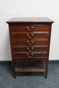 An antique mahogany five drawer music chest containing sheet music